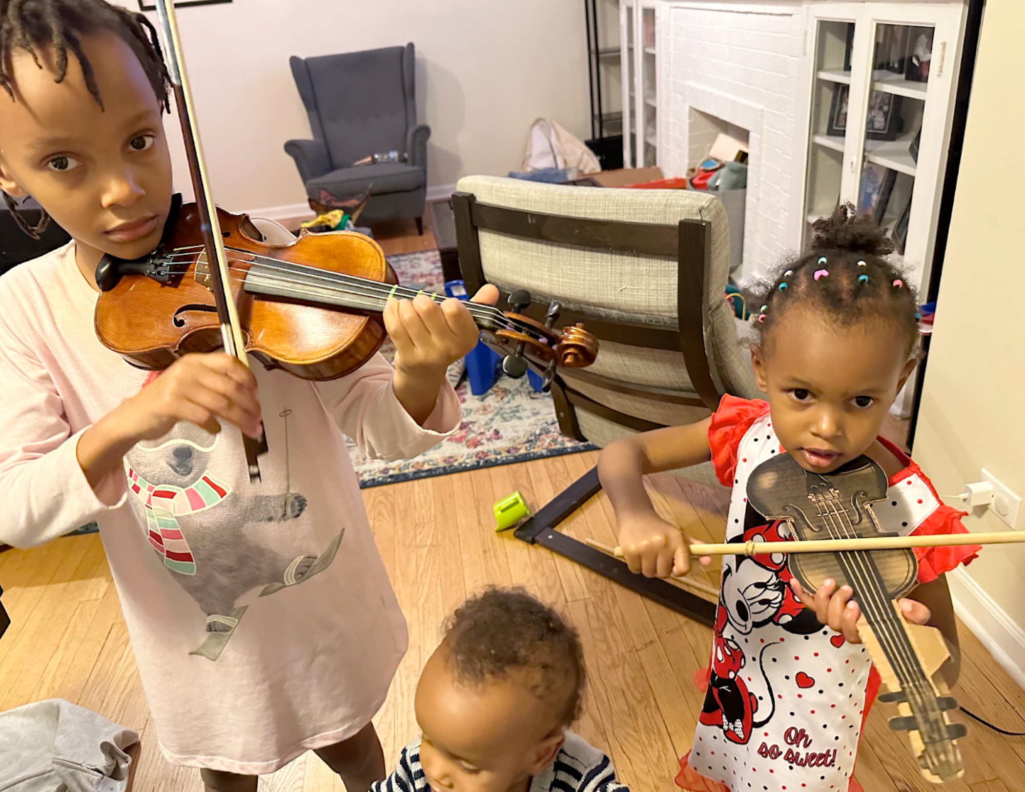 Emmy (age 3), trying to copy her sister Ella on the violin