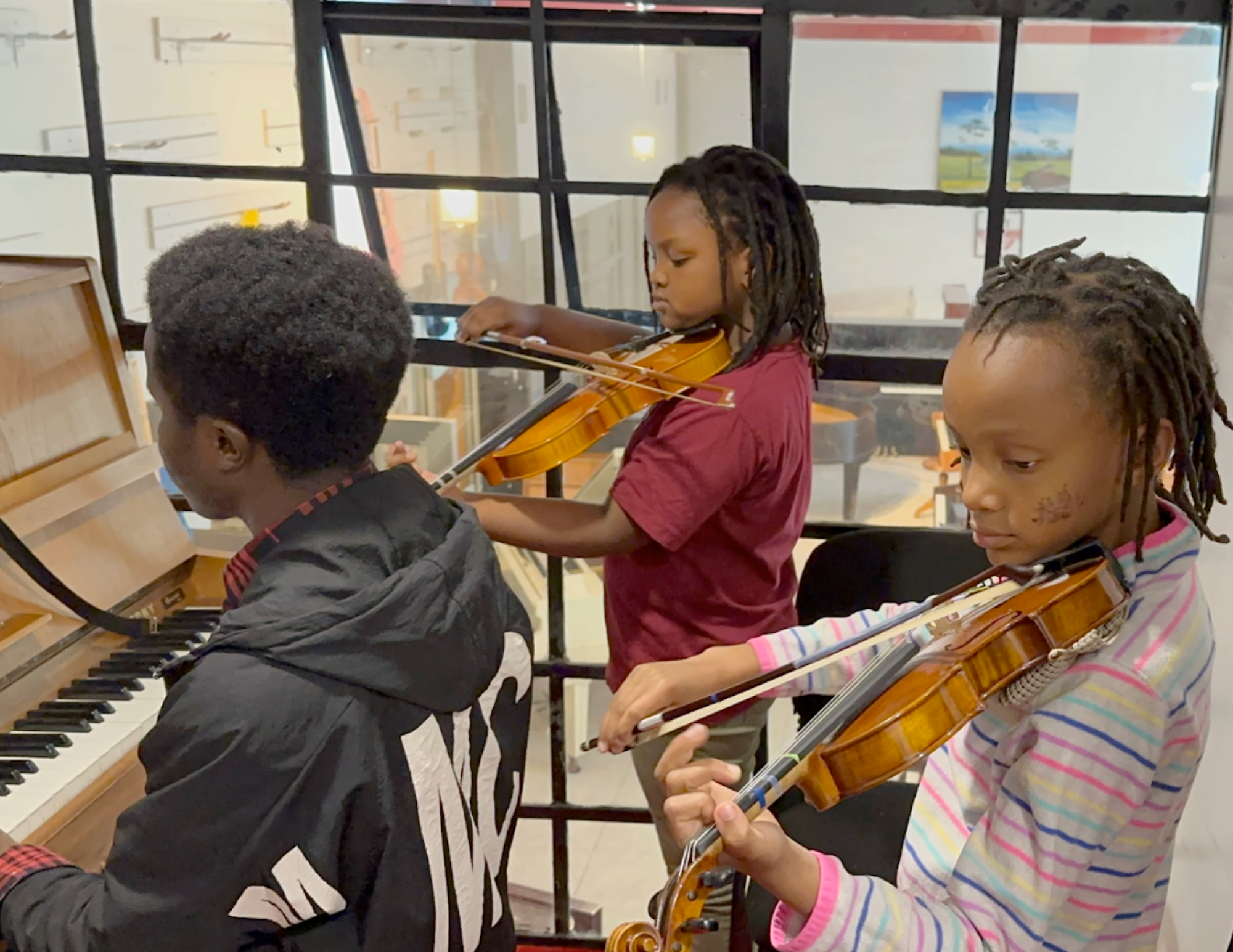 Ella and cousin Wambui at her violin lesson in Nairobi, Kenya