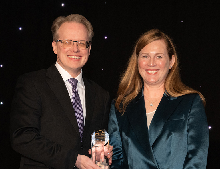 John Magnum accepts the MIC Dushkin Award from Shalisa Kline Ugaz